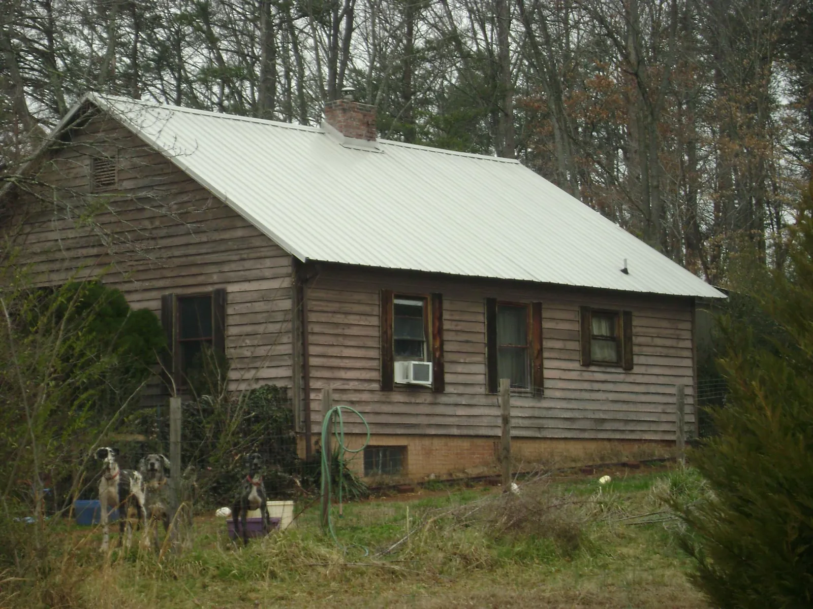 White metal roof on an old wood sided farmhouse, from a Asphalt Shingle Roof Repair job in Neelyton